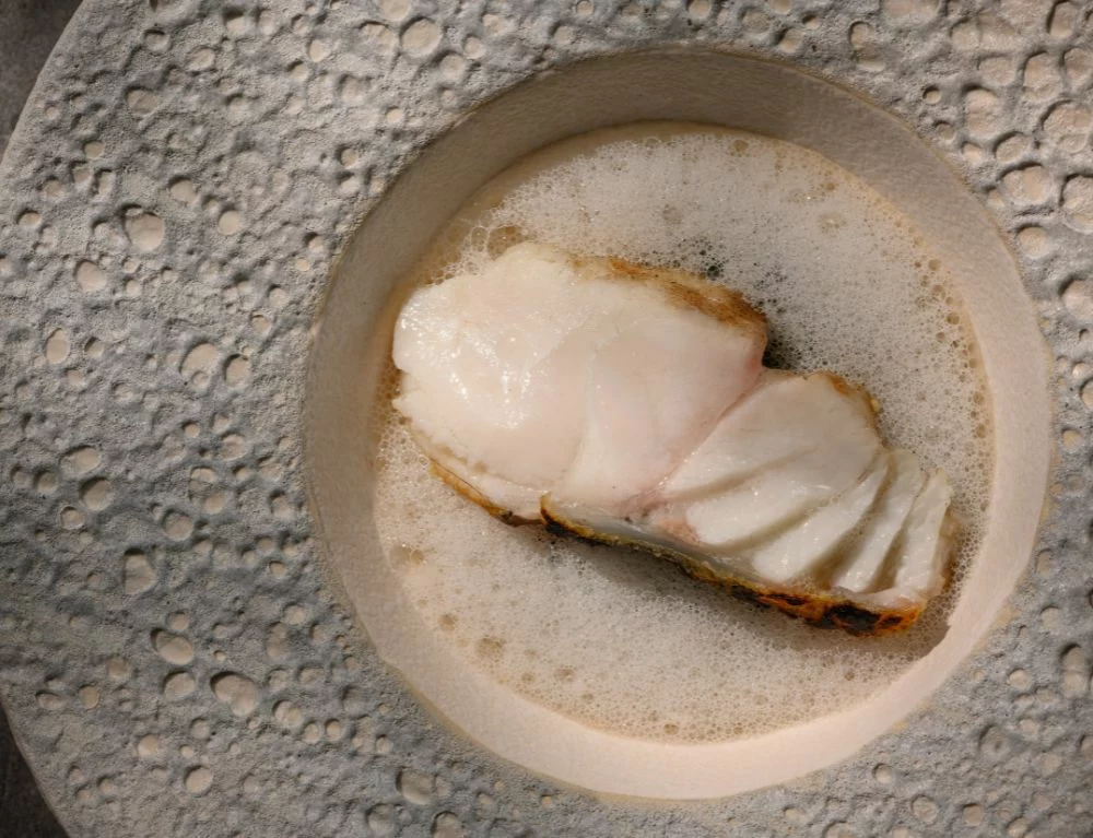 The steamed grouper is served with fermented Cao Bang bamboo shoots, delivering a bold, unforgettable flavor that leaves a lasting impression on every diner at Chapter Dining
