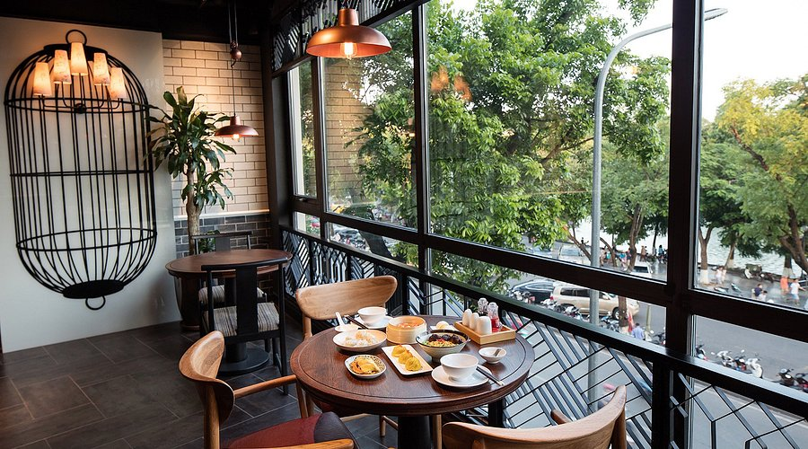 Enjoying egg coffee at Café Đinh, where Hanoi’s coffee culture unfolds in a nostalgic, lakeside setting