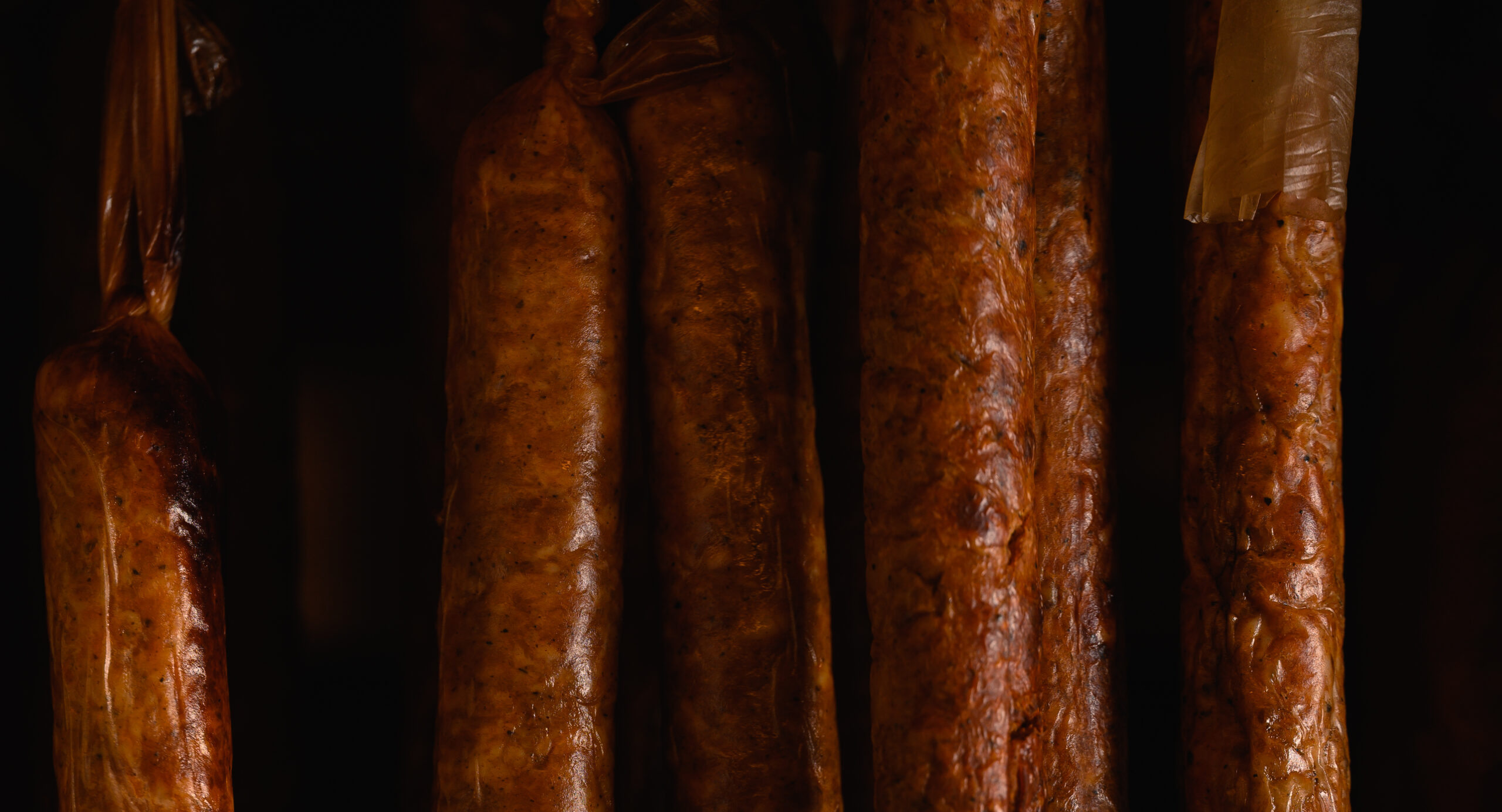 Traditional smoked Vietnamese sausage hanging over a wood fire hearth in the Northern highlands