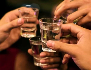 A cultural ritual, rice wine is poured meaningful Vietnamese celebrations