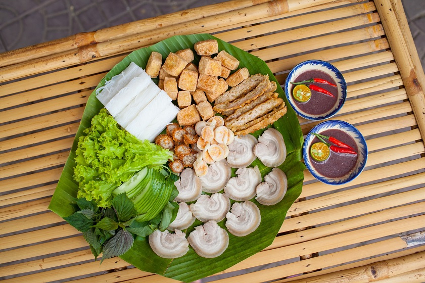 Bun dau mam tom served with tofu, herbs, pork, and Vietnamese shrimp paste in Hanoi