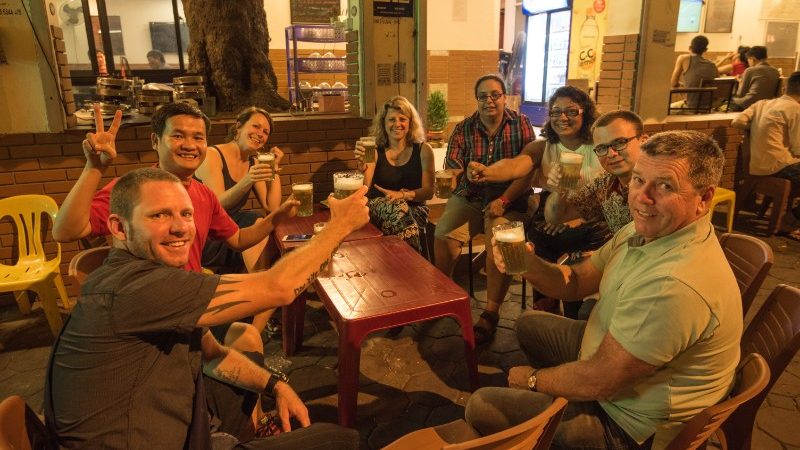 Travelers experiencing bia hoi Hanoi as part of Hanoi food culture