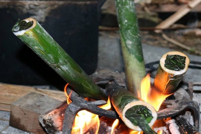 Traditional cơm lam cooking over a fire in Northwest Vietnam