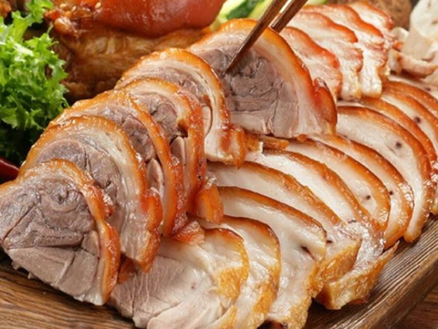Grilled lợn cắp nách mountain pork served with herbs and dipping salt