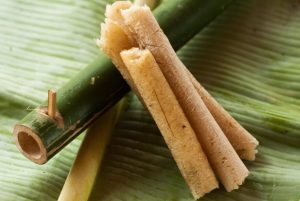 Vietnamese bamboo rice cơm lam served in a peeled bamboo tube