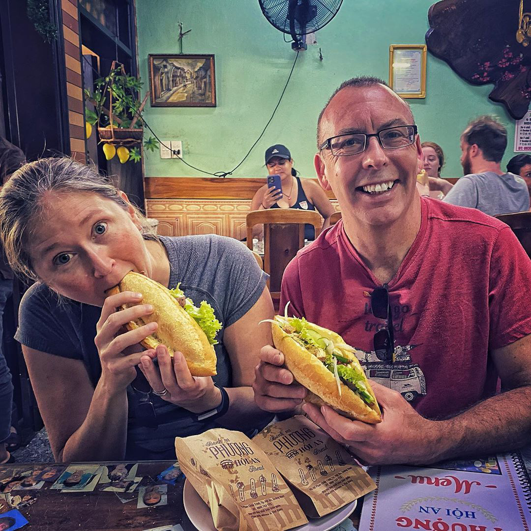 International traveler enjoying Vietnamese banh mi in Hanoi