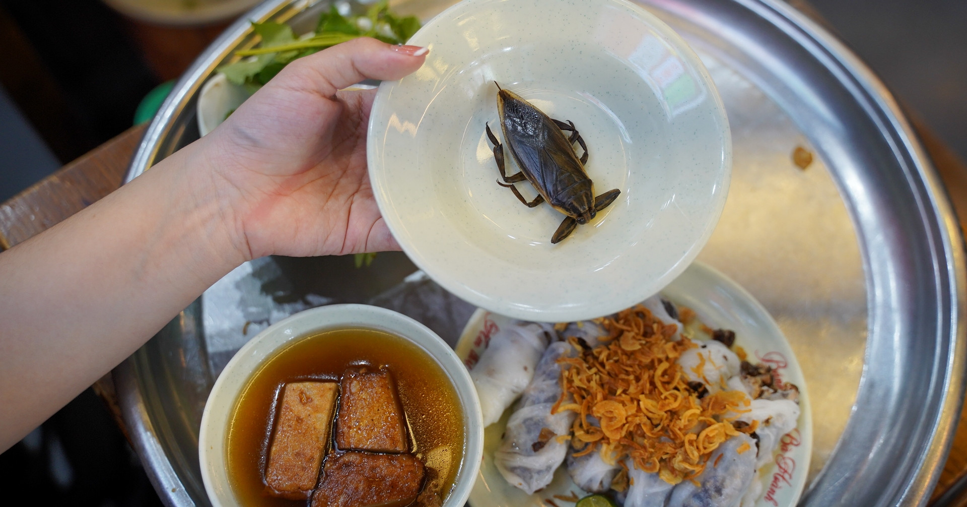 Chả quế and cà cuống served as aromatic accompaniments to banh cuon Hanoi