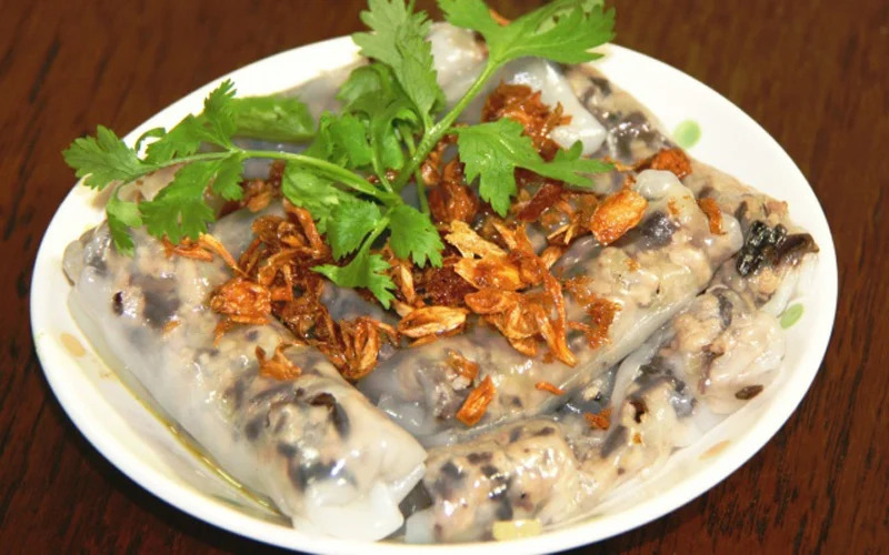 Pork and wood ear mushroom filling added to a thin banh cuon wrapper