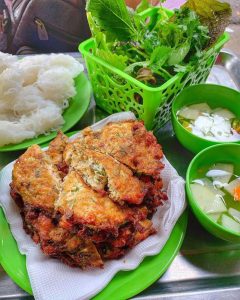 Golden chả rươi served hot with herbs and dipping sauce during autumn in Hanoi