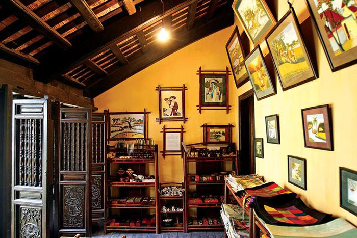 Courtyard and wooden interior of Mã Mây Heritage House in Hanoi Old Quarter