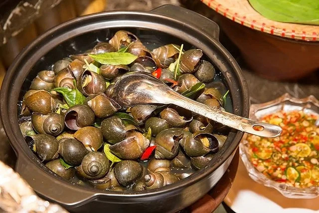 Steamed snails with lemongrass and ginger dipping sauce on a cool Hanoi evening