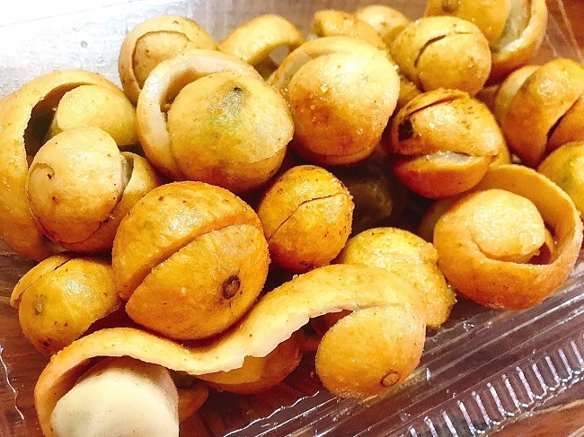 Ripe yellow sấu seasoned with sugar, salt and chilli during early autumn in Hanoi