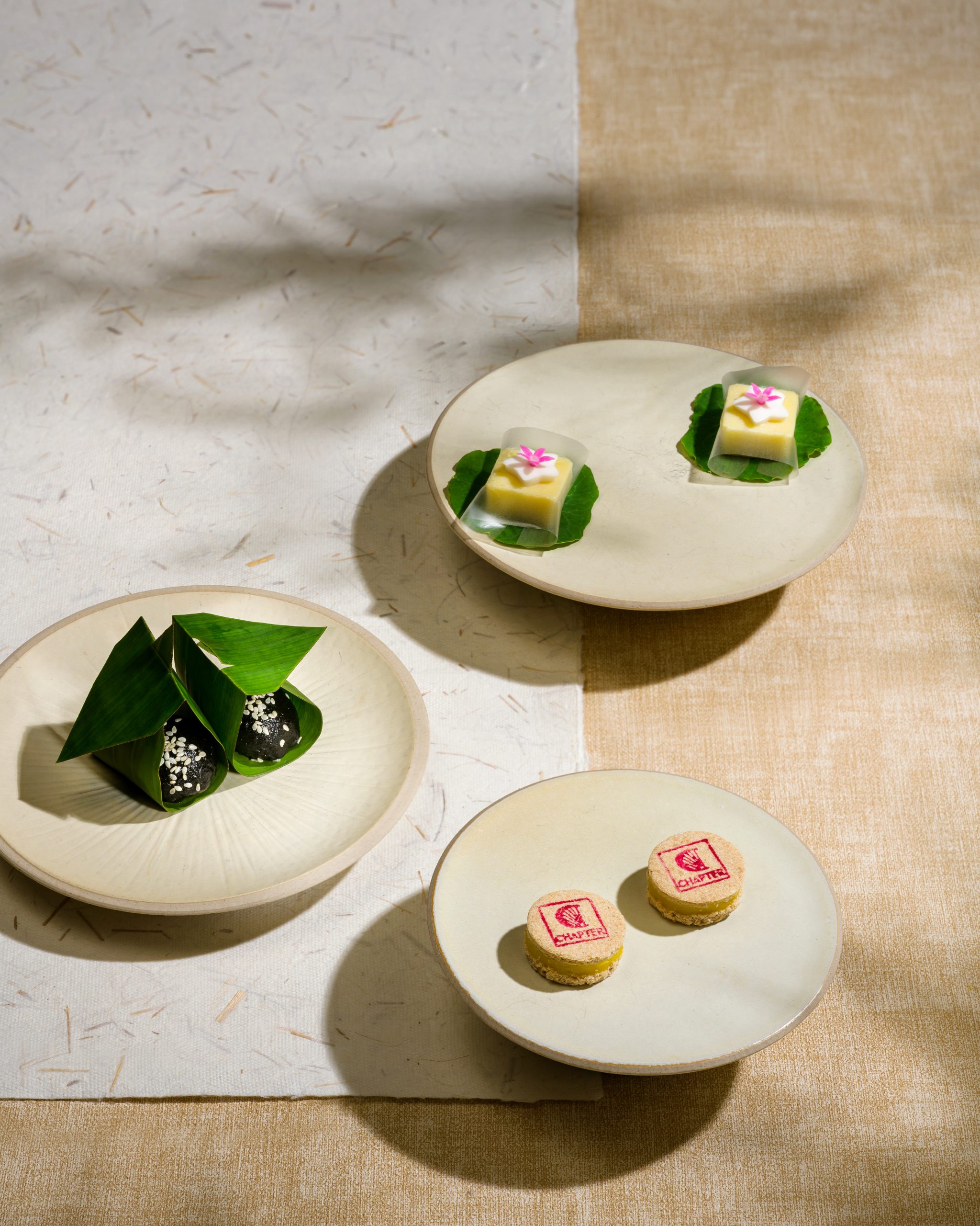 Vietnamese fine dining Petit Fours with tropical fruit, jasmine macaron and steamed ramie cake