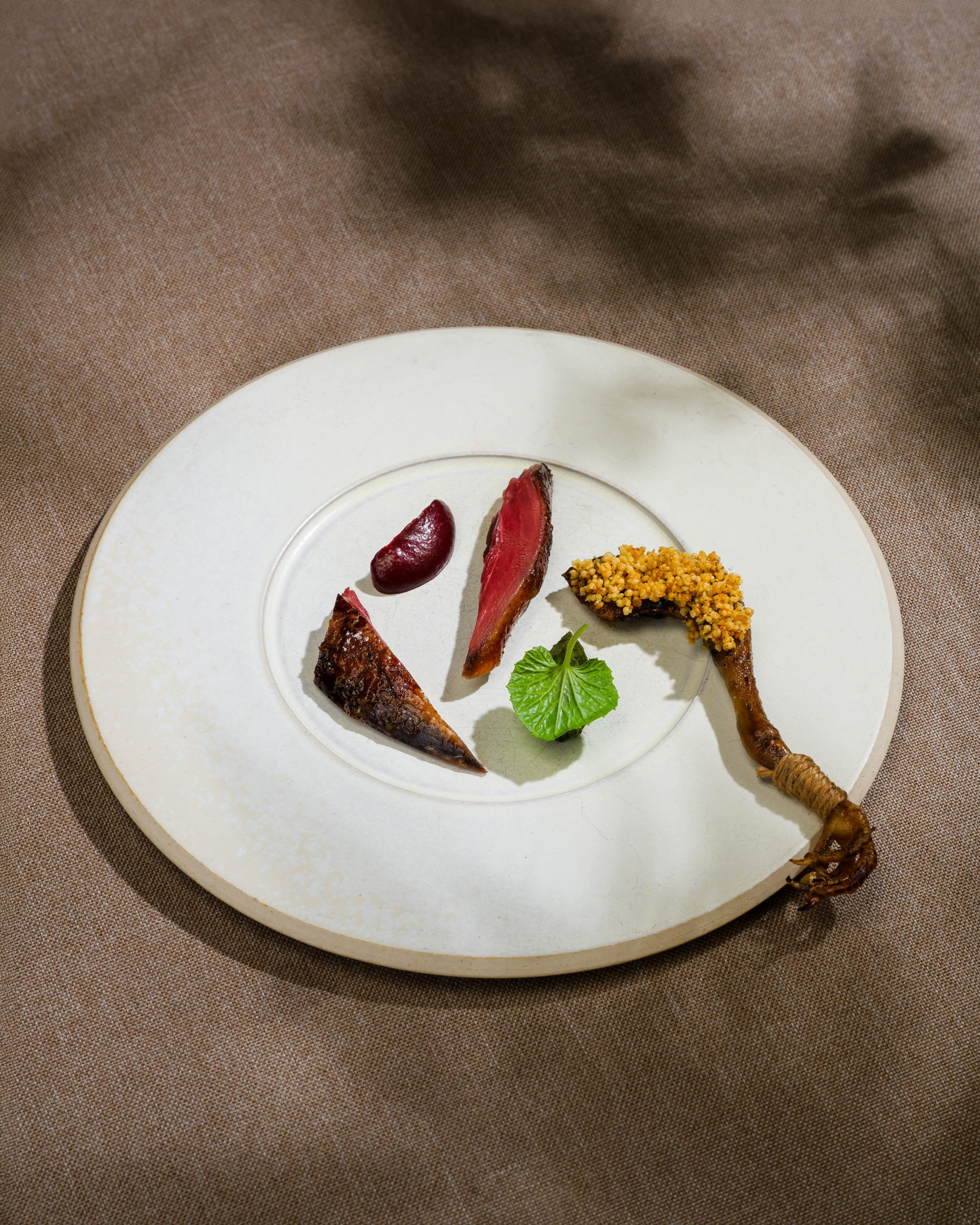 Vietnamese fine dining dish with pigeon, northern plum and mắc mật