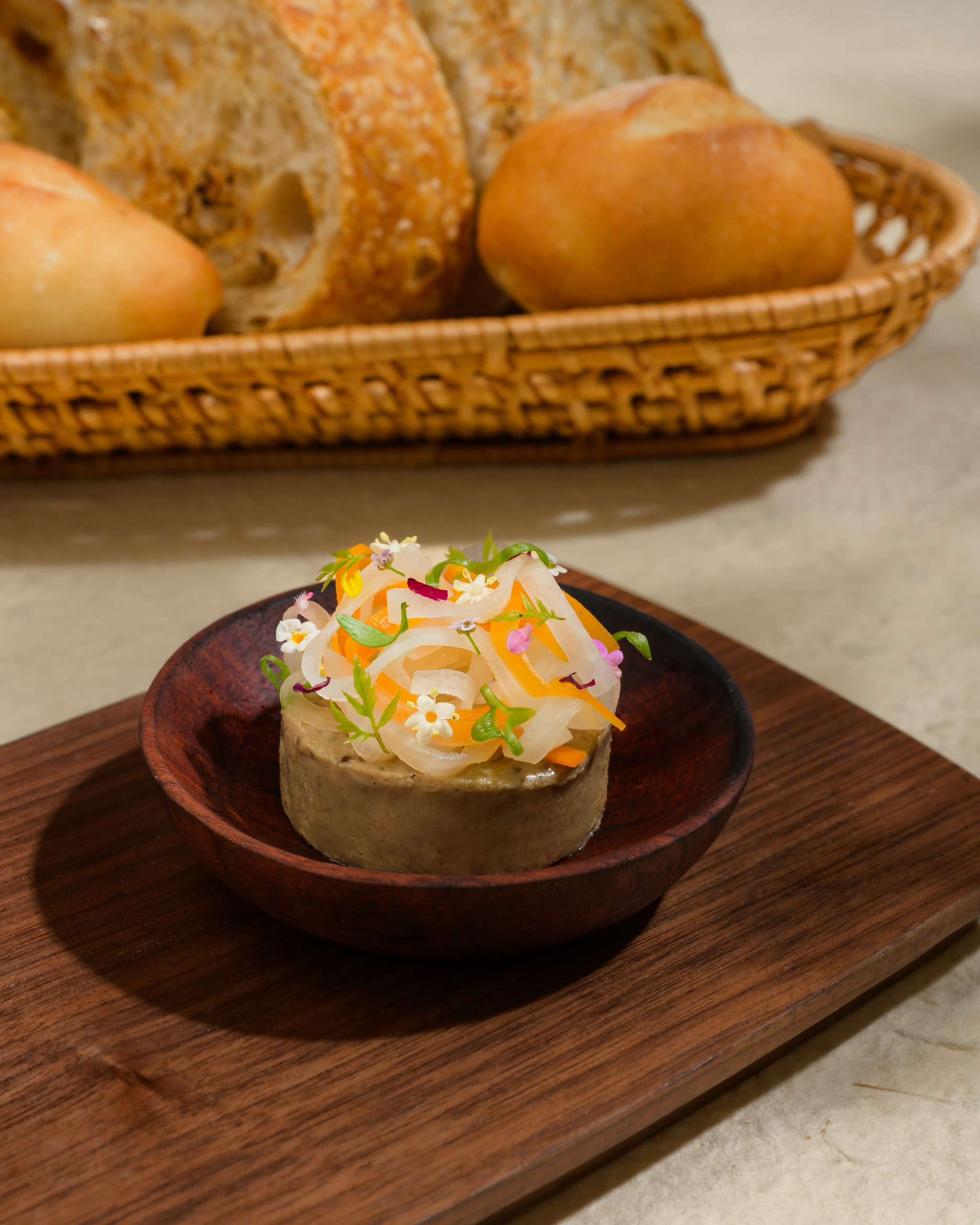 Pâté, smoked butter and pickles served with millet bánh mì