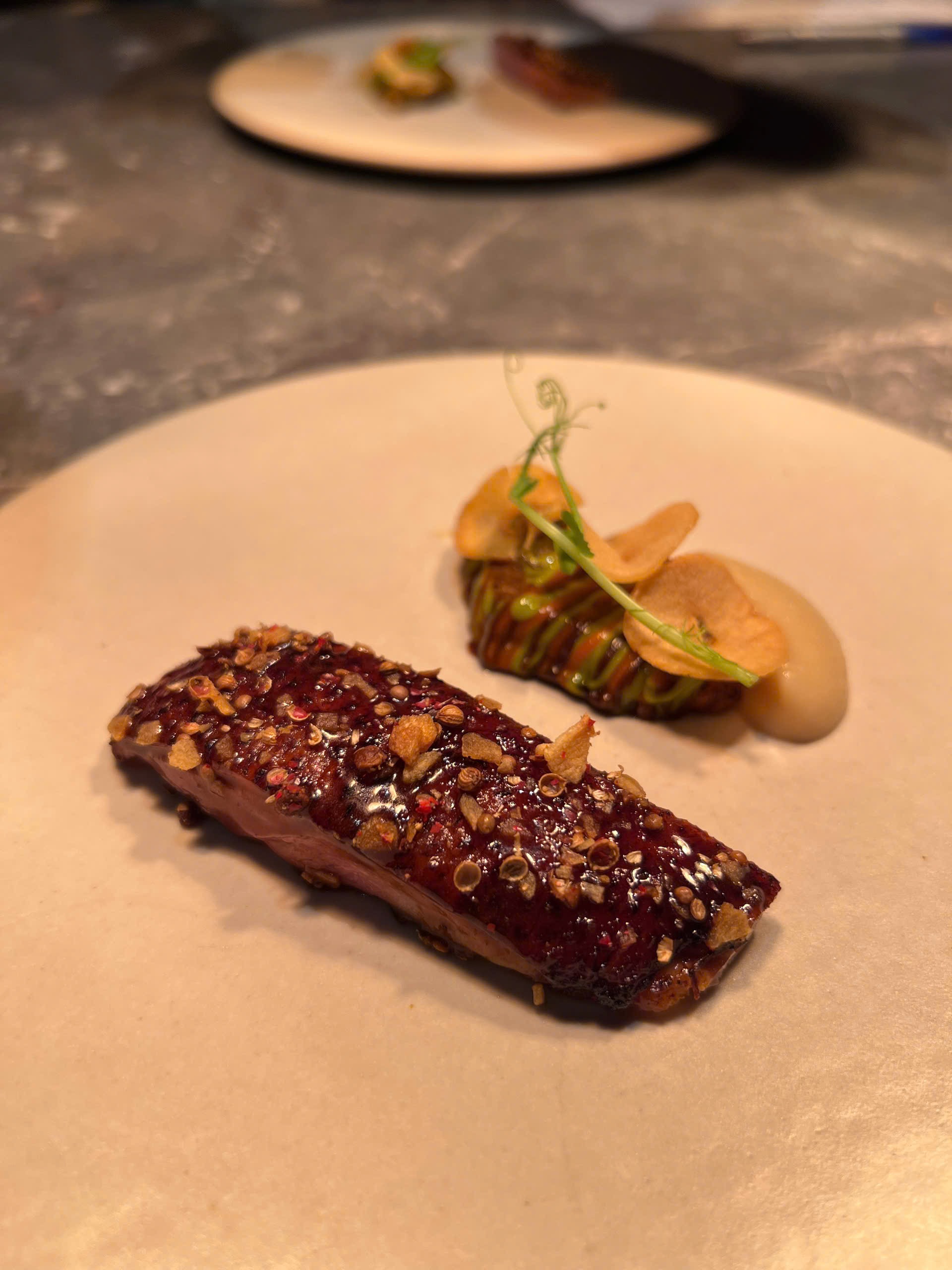 Charcoal-grilled beef meets smoked brown butter, alongside a tomato tatin