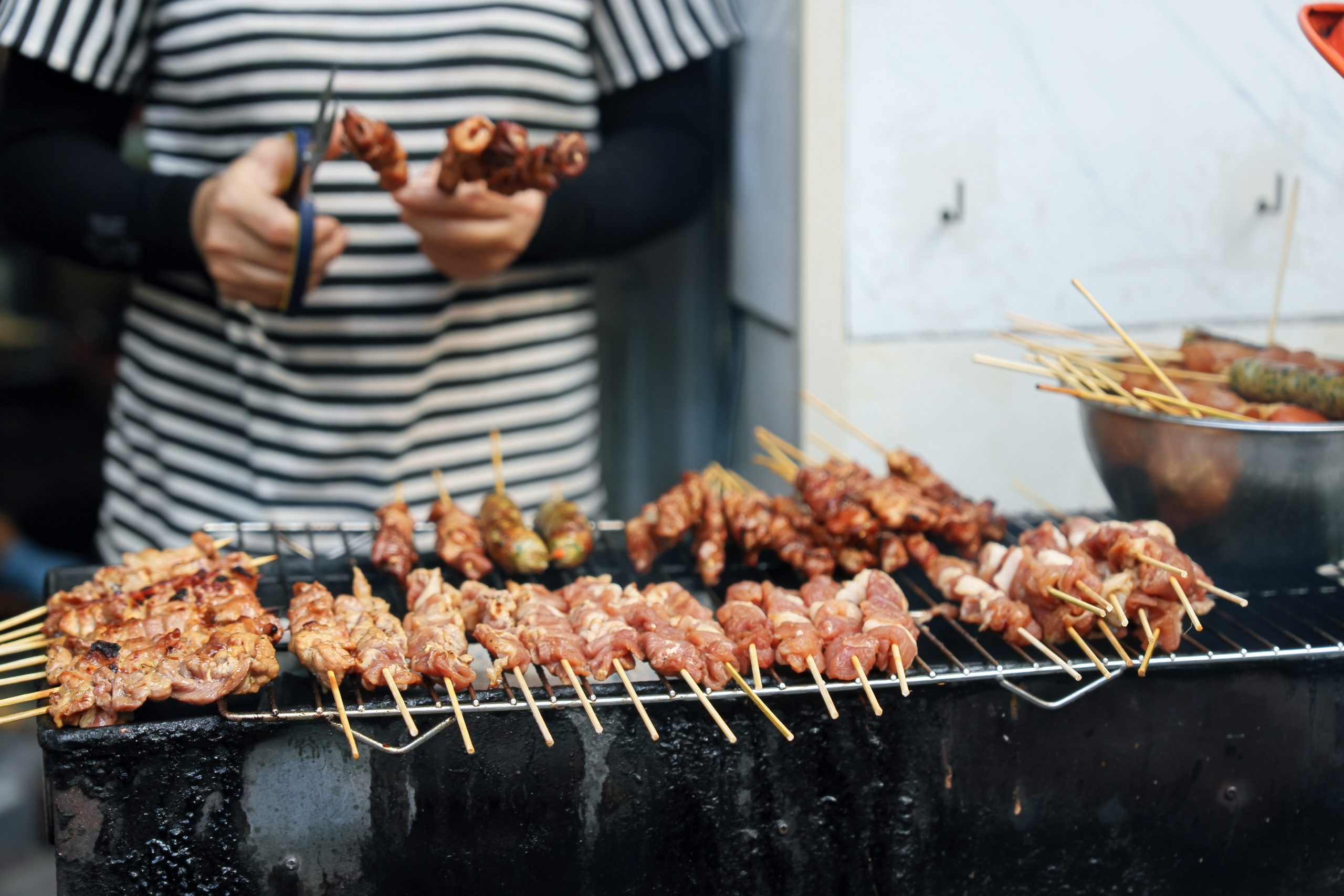 Over charcoal-grilled pork skewers, the chefs exchange ideas on how a familiar Hanoi street food might inspire a tasting menu