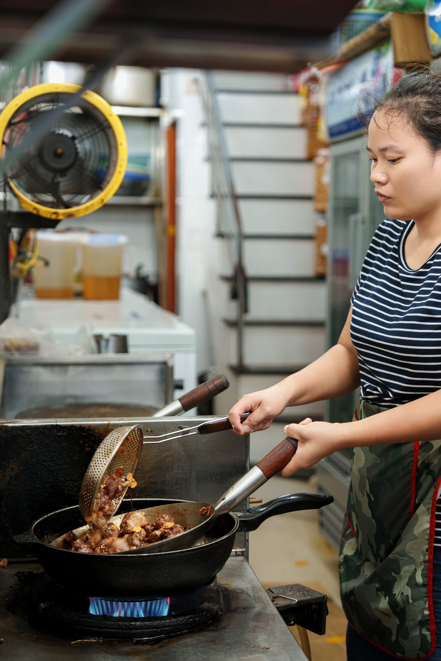 On Hàng Thiếc Street, the chefs discover local approaches to seasoning and preparing              garlic-fried duck.