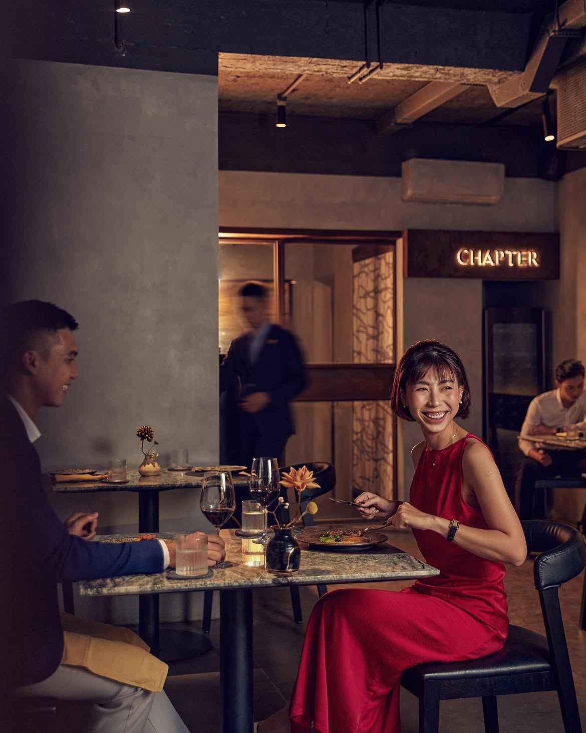 Elegant wood-fired dining space at Chapter restaurant decorated for Vietnamese Women's Day in Hanoi