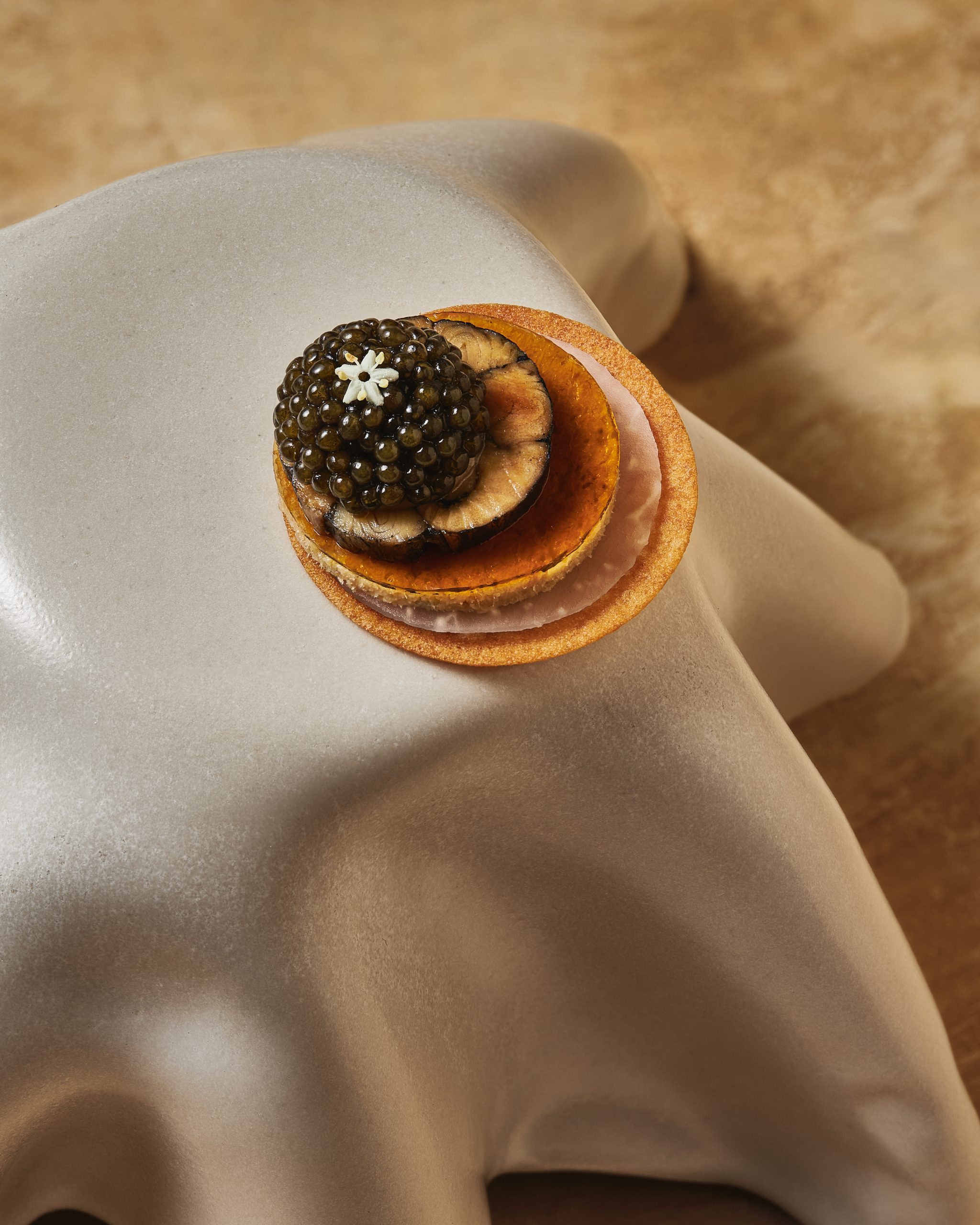 Smoked eel with caviar and fermented chili served at Chapter main dining table