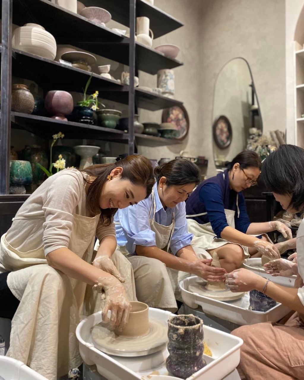 Team members enjoying a pottery workshop at Vuonceramic for Vietnamese Women's Day Hanoi celebration